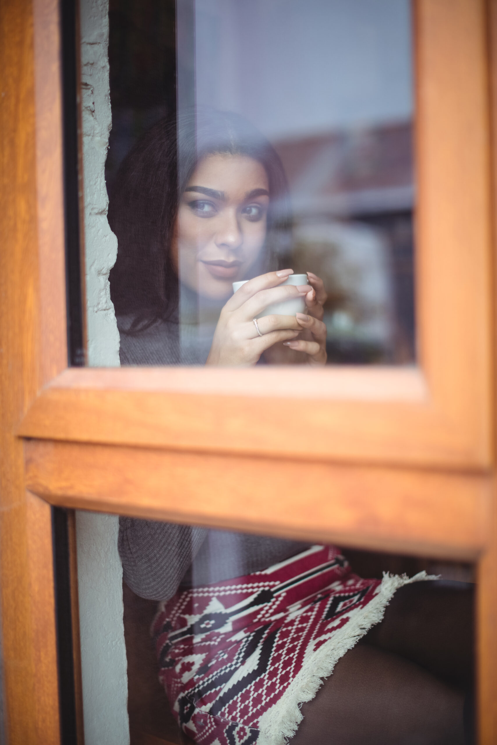Thoughtful woman having a cup of coffee in café